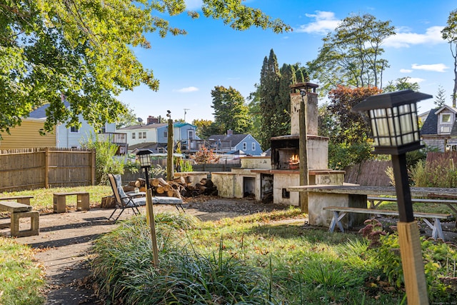 view of yard featuring exterior fireplace