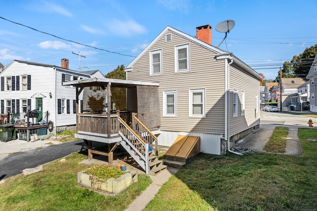 rear view of property with a gazebo and a lawn