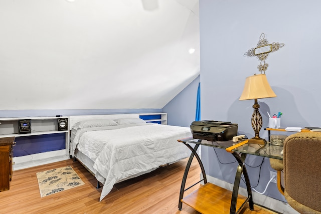 bedroom with lofted ceiling and hardwood / wood-style flooring