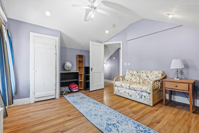 sitting room with wood-type flooring, vaulted ceiling, and ceiling fan