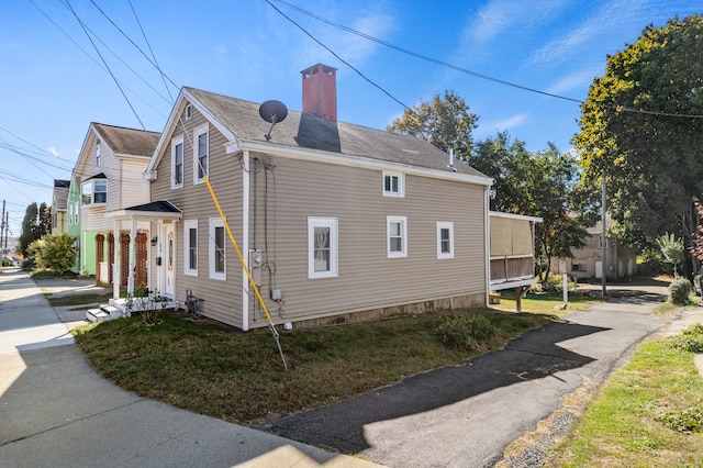 view of side of home featuring a lawn