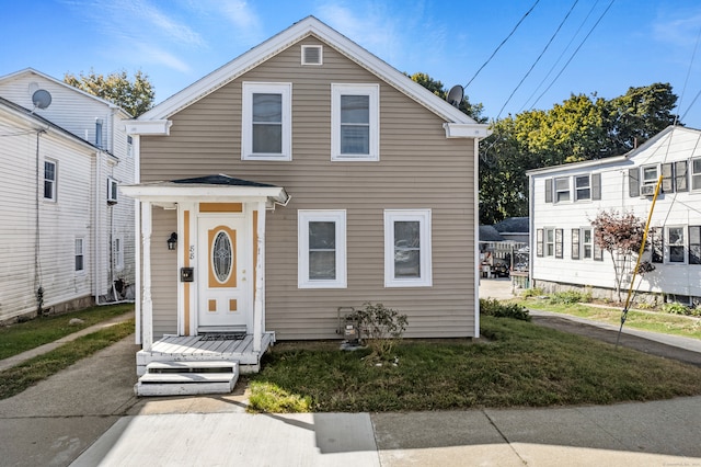 bungalow-style home with a front lawn