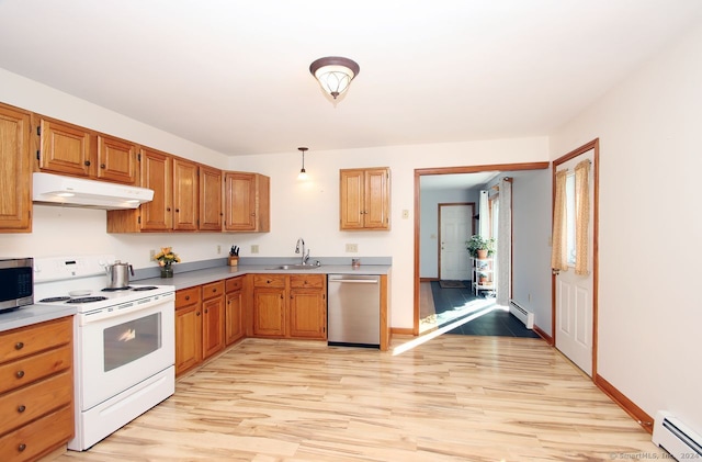 kitchen with pendant lighting, sink, baseboard heating, and appliances with stainless steel finishes