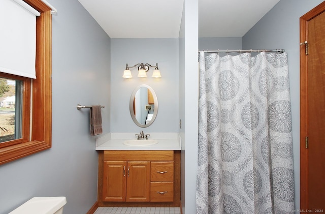 bathroom featuring tile patterned flooring, a shower with curtain, and vanity