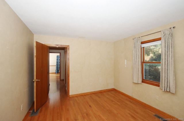 spare room featuring hardwood / wood-style flooring