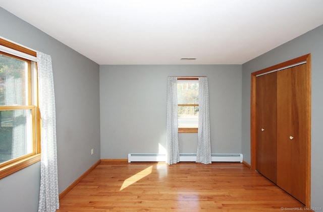 unfurnished bedroom featuring light hardwood / wood-style floors and a closet