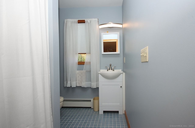 bathroom featuring tile patterned floors, vanity, toilet, and baseboard heating