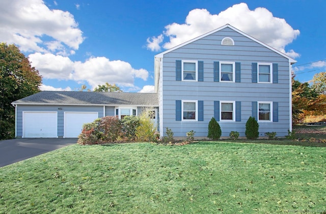 view of front of home featuring a garage and a front yard