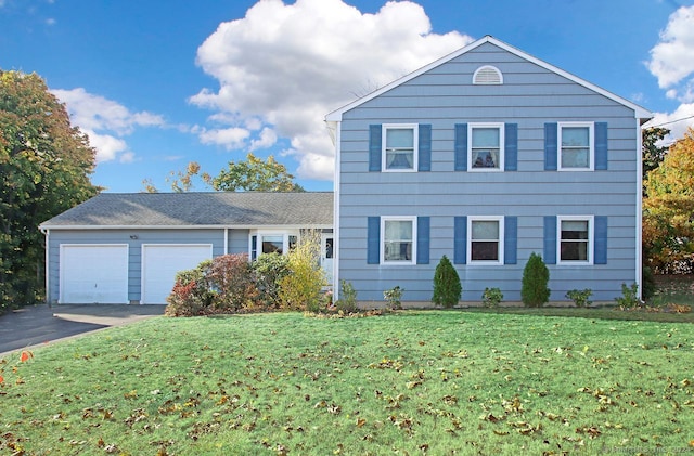 view of front of property with a front yard and a garage