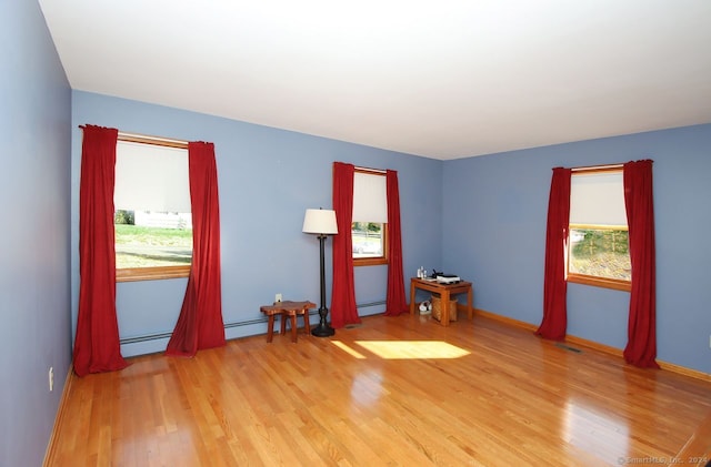 spare room with light hardwood / wood-style flooring