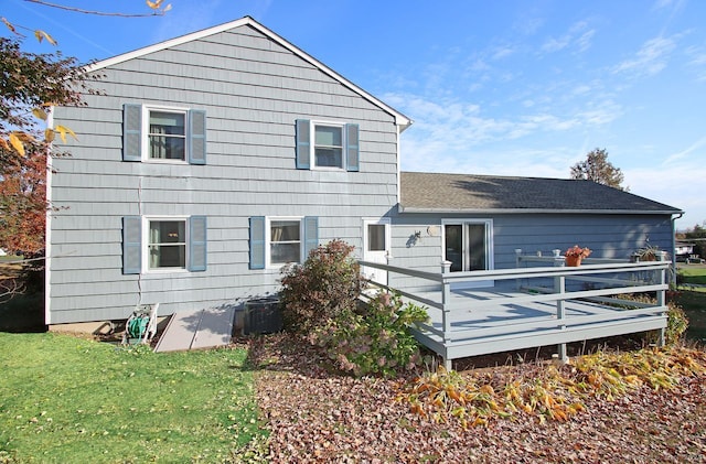 back of house with central AC, a yard, and a deck