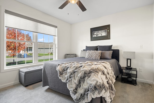 bedroom with light colored carpet and ceiling fan