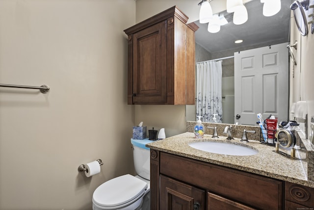 bathroom with vanity, a shower with shower curtain, and toilet