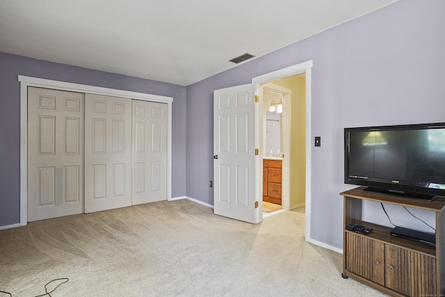 carpeted bedroom with a closet