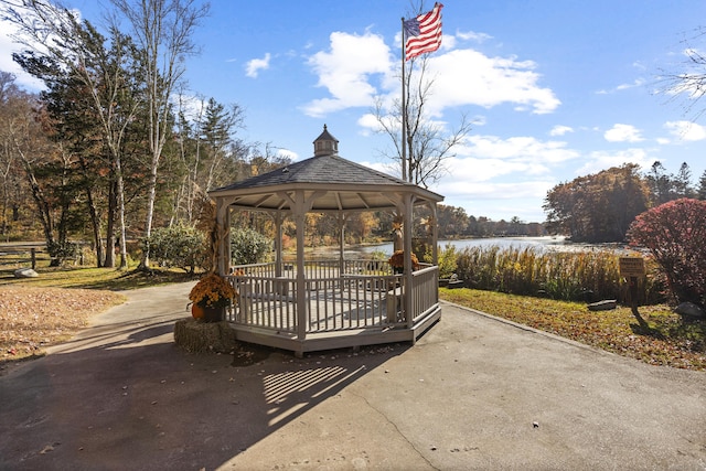 surrounding community with a gazebo and a water view