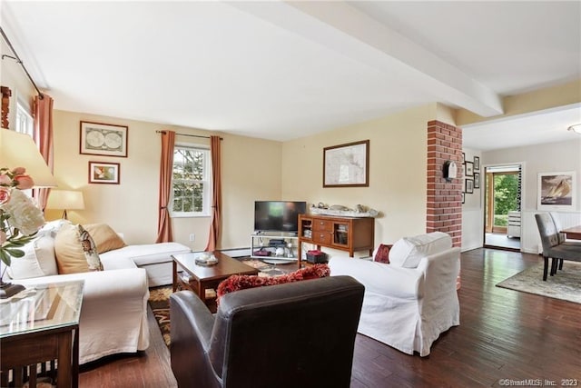 living room featuring beamed ceiling and dark hardwood / wood-style flooring