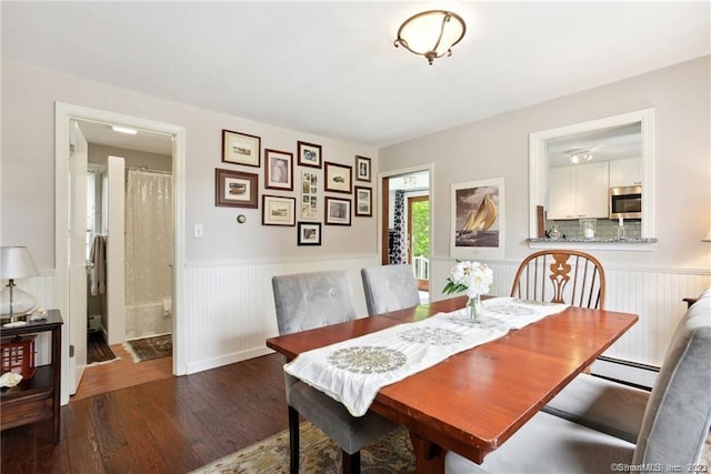 dining area featuring dark hardwood / wood-style flooring and a baseboard radiator