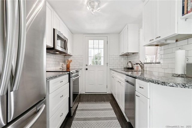 kitchen featuring light stone countertops, white cabinetry, sink, and stainless steel appliances