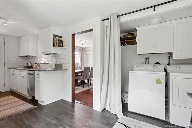 laundry area featuring cabinets, washer and dryer, dark hardwood / wood-style flooring, and sink