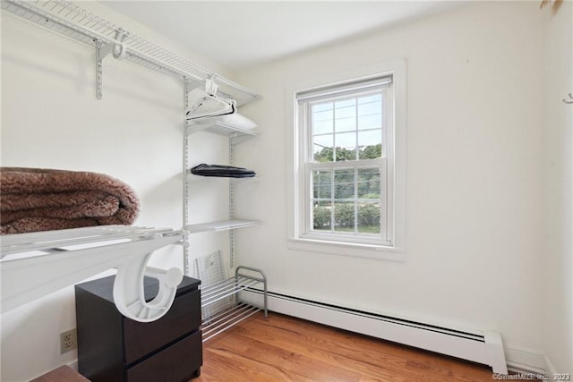 interior space with baseboard heating and hardwood / wood-style floors