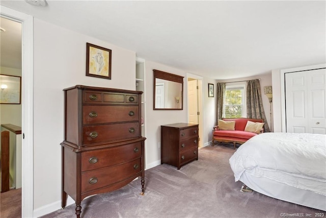 bedroom featuring light carpet and a closet