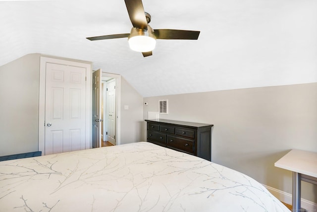 bedroom featuring lofted ceiling, baseboards, visible vents, and a ceiling fan