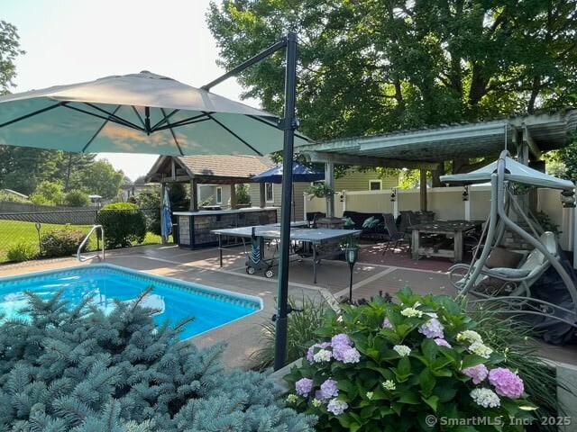 view of swimming pool featuring fence, a fenced in pool, and a patio