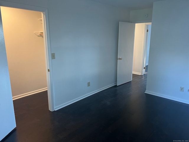 spare room with dark hardwood / wood-style flooring