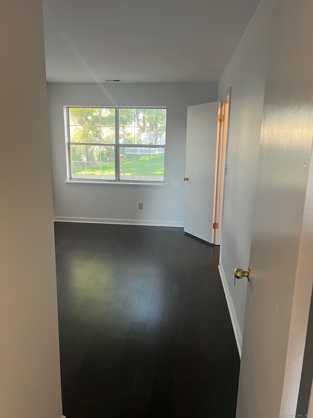 empty room featuring dark hardwood / wood-style flooring