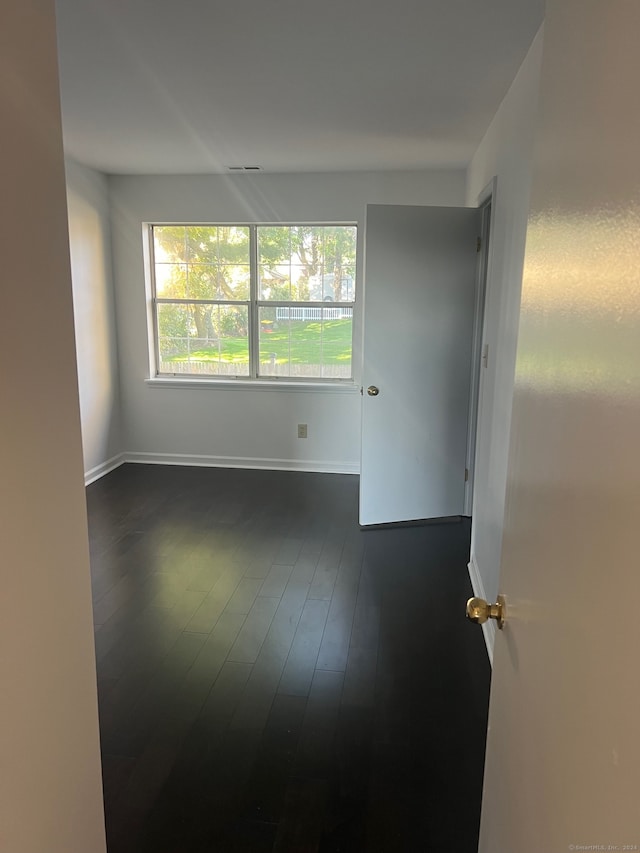 empty room with dark hardwood / wood-style floors