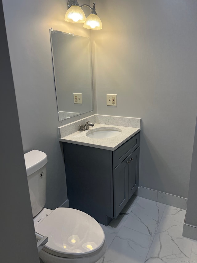 bathroom with toilet and vanity