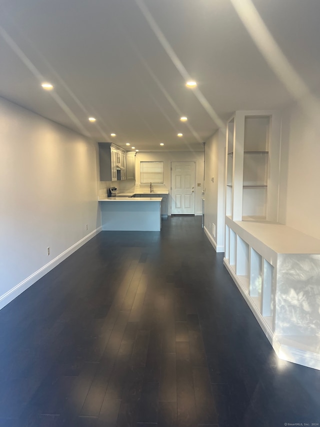 unfurnished living room with dark wood-type flooring