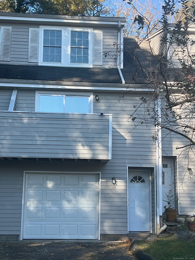 back of house featuring a garage