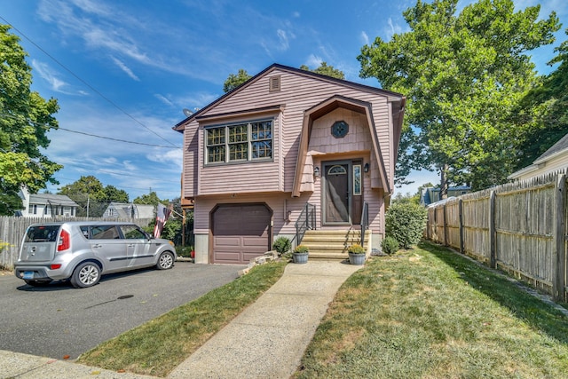 view of front facade with a front yard and a garage