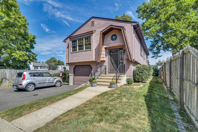 view of front of property with a front lawn and a garage