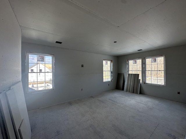 unfurnished room featuring plenty of natural light