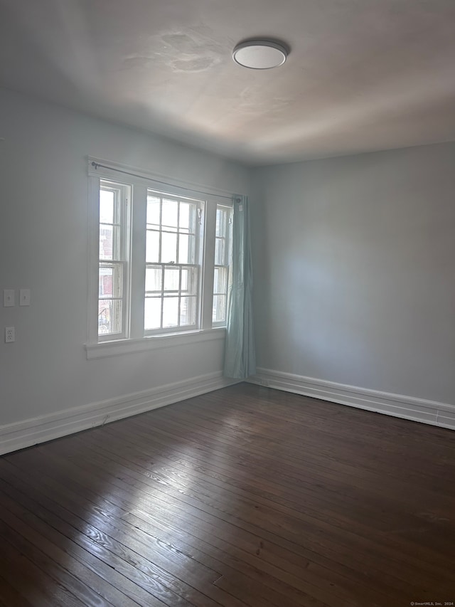 spare room with dark hardwood / wood-style flooring