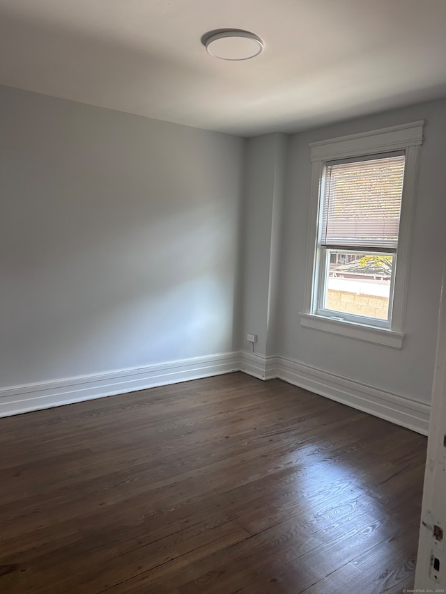 spare room with dark hardwood / wood-style flooring