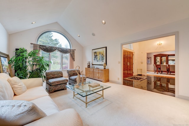 carpeted living room featuring high vaulted ceiling