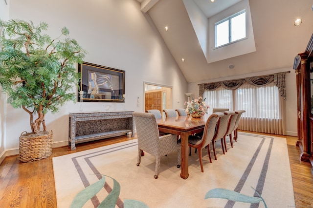 dining room featuring light hardwood / wood-style flooring and high vaulted ceiling