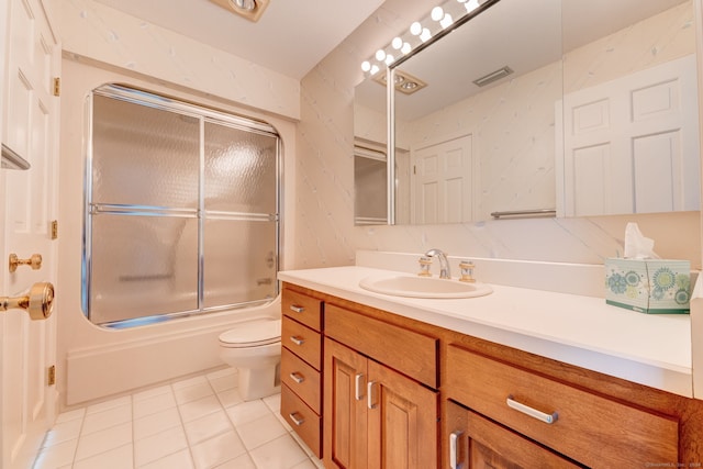 full bathroom featuring bath / shower combo with glass door, vanity, toilet, and tile patterned floors