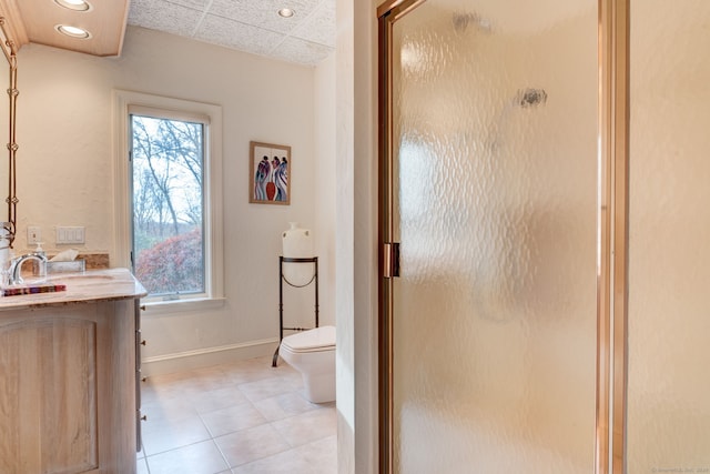 bathroom with tile patterned floors, a paneled ceiling, vanity, an enclosed shower, and toilet