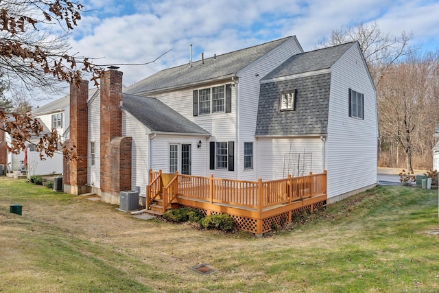 rear view of house featuring a wooden deck, central AC, and a yard