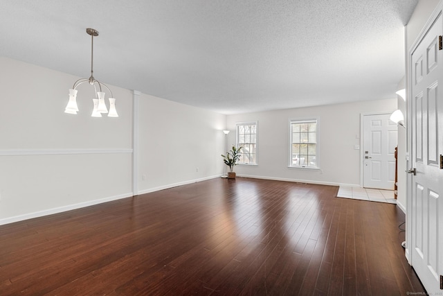 interior space featuring dark hardwood / wood-style floors and a chandelier