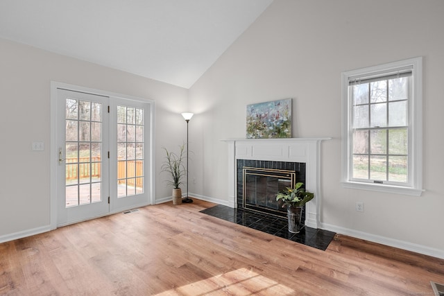 living room featuring light hardwood / wood-style flooring and high vaulted ceiling