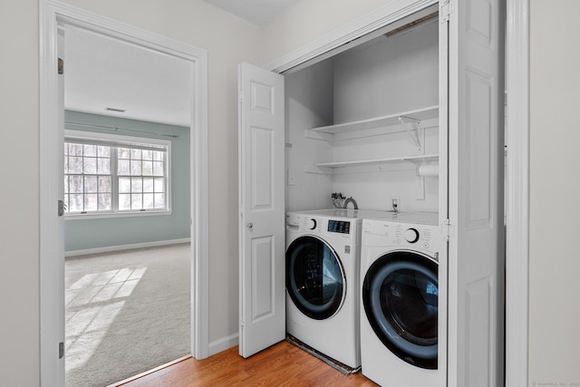 washroom featuring separate washer and dryer and light wood-type flooring