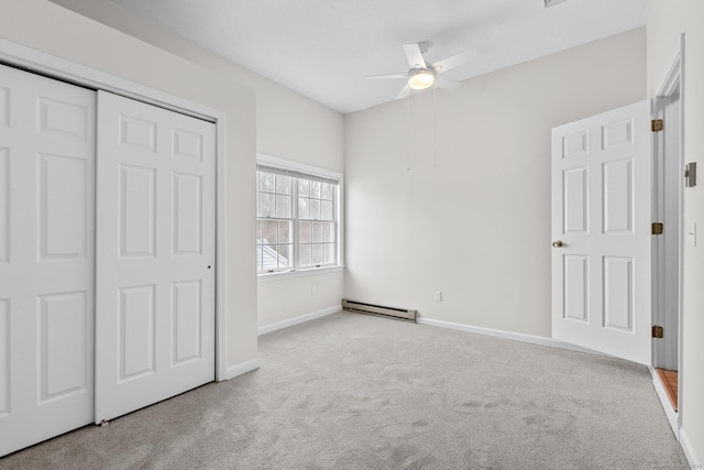 unfurnished bedroom featuring ceiling fan, a closet, light colored carpet, and a baseboard radiator