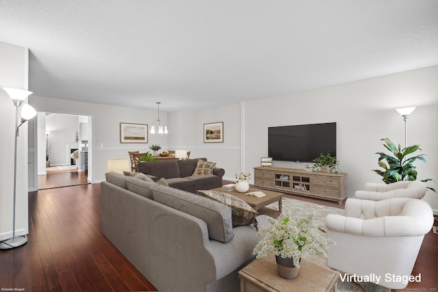 living room featuring dark hardwood / wood-style flooring and a notable chandelier