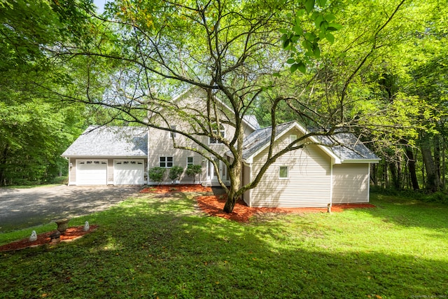 view of front of house with a front lawn and a garage