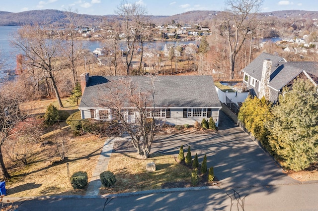 birds eye view of property with a water and mountain view